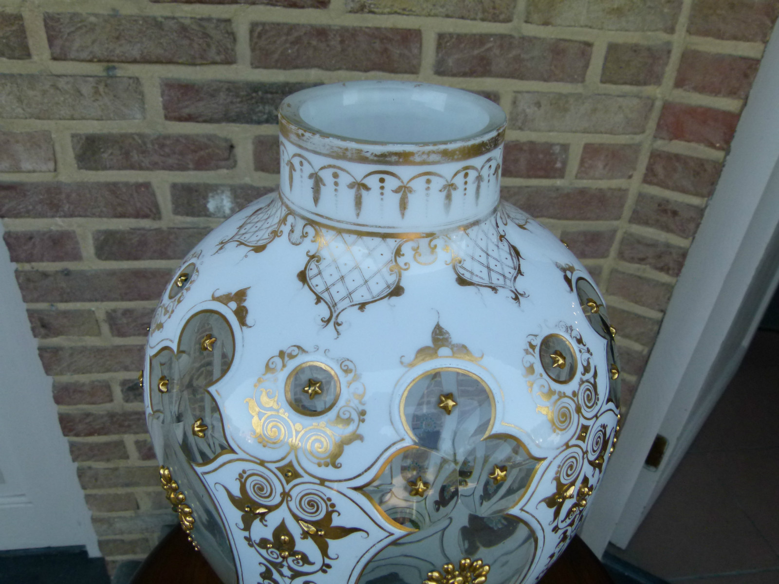A white and gold Bohemian vase.