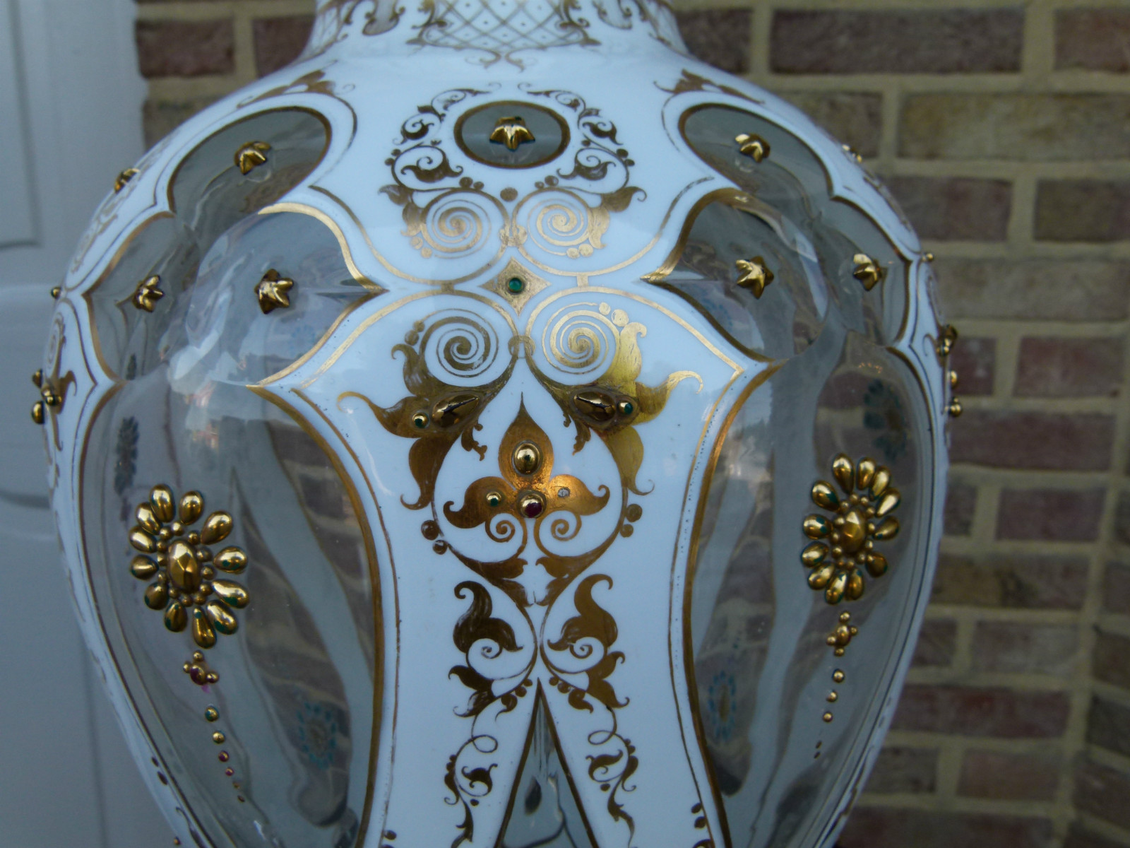 A white and gold Bohemian vase.