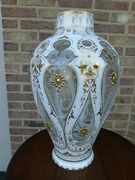 A white and gold Bohemian vase.