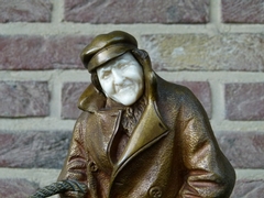 Belle epoque style Sculpture by H. Sécarel of a man with ivory face in multi color patinated bronze, France 1900