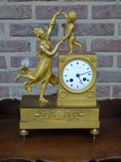 Empire style Miniature pendule clock with a lady and child in gilded bronze, France 1815