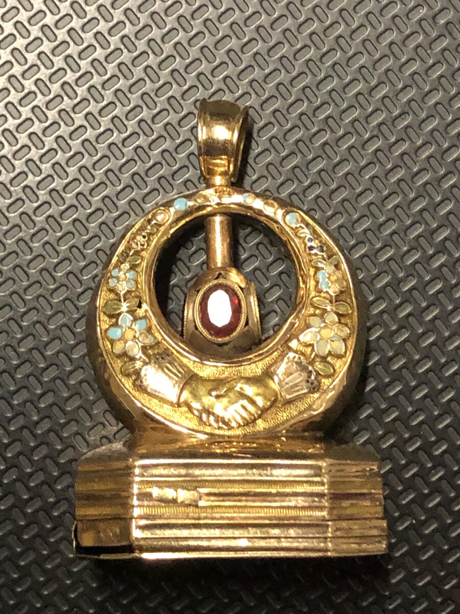 Miniature music box in gold with stone