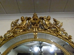 Napoleon III style Huge gilded oval mirror with putto,s, France 1880