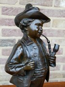 Napoleon III style Sculpture of a pipe smoking boy signed by Melane in patinated bronze, France 1880