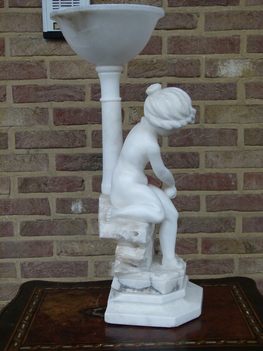 Sculpture and light of a young girl playing with a cat