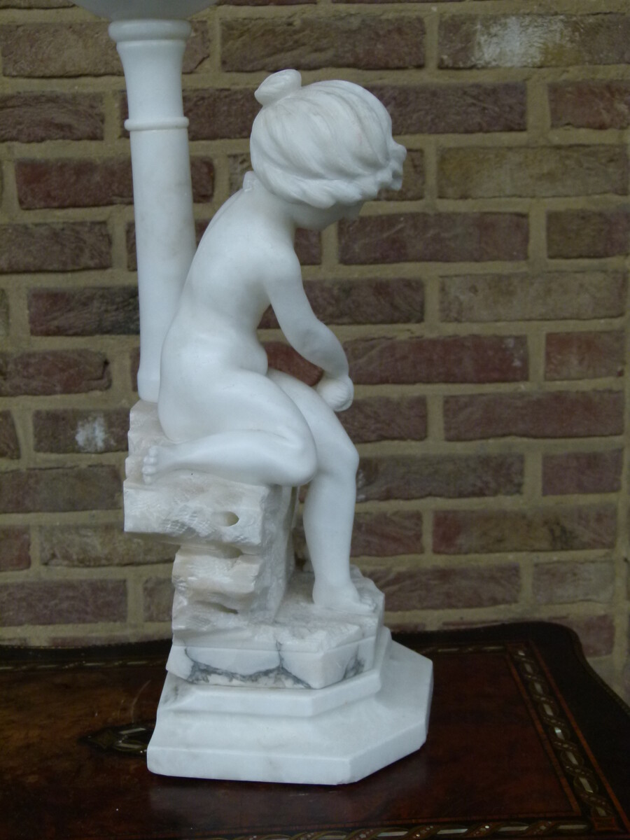 Sculpture and light of a young girl playing with a cat