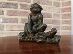 Signed with a V.1902 style Miniature bronze sculpture of a monkey in patinated bronze 1900