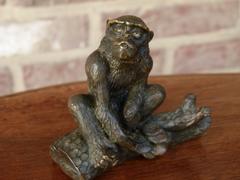 Signed with a V.1902 style Miniature bronze sculpture of a monkey in patinated bronze 1900