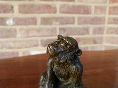 Signed with a V.1902 style Miniature bronze sculpture of a monkey in patinated bronze 1900